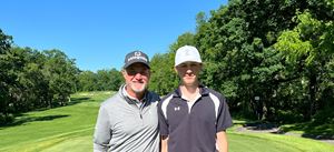 Jerry Kelly and Noah Weidner stand together on a golf course