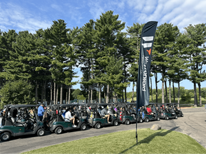 Golfers lining up in golf carts to head out to the course during the Chip In to End Hunger event.