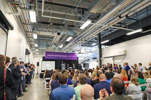 Neighbors, community leaders and local officials fill the seating area just outside the doors to the laboratory.