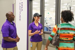 Tour hosts speak with guests about the laboratory's operations.